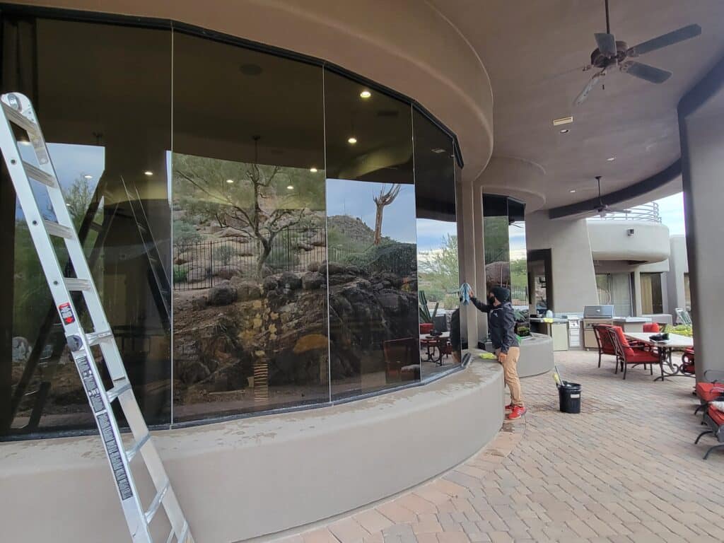 Image of a store with large commercial windows. You can see one of Ace Window Cleaners washing the windows