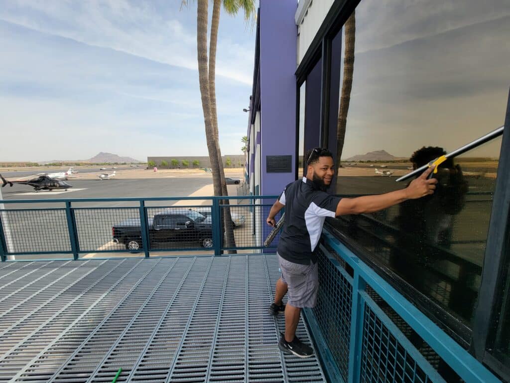 Image of a Highrise window cleaning service. You can see a Ace Window Cleaning expert cleaning a large highrise window.