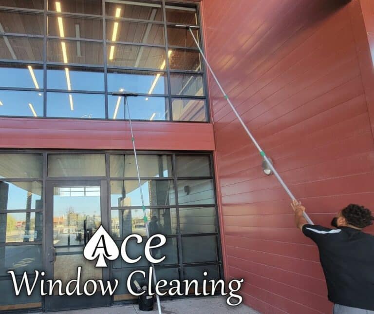 Image of Window Cleaning Service for businesses. You can see a Window Cleaner at work with a commercial window.