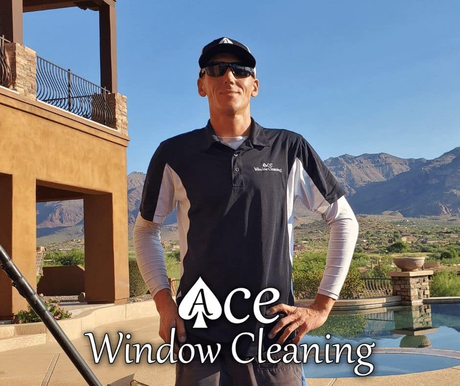 Image of Ace Window Cleaning owner standing infrint of a residential home that has recived a window cleaning service